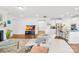 Open-concept living room with a fireplace, hardwood floors, and an adjacent kitchen with bar seating at 12305 Stinson Ct, Charlotte, NC 28277