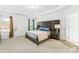 A primary bedroom features an upholstered headboard and is illuminated by natural light at 12305 Stinson Ct, Charlotte, NC 28277