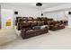 Home theater room featuring tiered seating, leather recliners, projector screen, and surround sound speakers at 12305 Stinson Ct, Charlotte, NC 28277