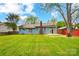 Backyard with blue siding, green grass and a wood deck at 13417 Krislyn Woods Pl, Charlotte, NC 28278