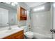 Bathroom with shower-tub combo, wood cabinet, and sink at 13417 Krislyn Woods Pl, Charlotte, NC 28278