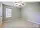 Bedroom featuring neutral walls, a window, and ceiling fan at 13417 Krislyn Woods Pl, Charlotte, NC 28278