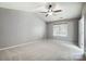 A neutral bedroom features a high ceiling with a ceiling fan and a window at 13417 Krislyn Woods Pl, Charlotte, NC 28278