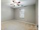 Bedroom features neutral paint, carpet, and window at 13417 Krislyn Woods Pl, Charlotte, NC 28278