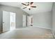 Bedroom has a ceiling fan and attached bathroom at 13417 Krislyn Woods Pl, Charlotte, NC 28278