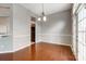 Cozy dining room featuring hardwood floors, elegant lighting, and access to outdoor patio at 13417 Krislyn Woods Pl, Charlotte, NC 28278