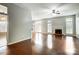 Bright living room with hardwood floors, fireplace, and large windows providing natural light at 13417 Krislyn Woods Pl, Charlotte, NC 28278