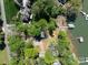 Aerial view of a waterfront property featuring mature trees and a private dock at 1395 Roundstone Rd, Sherrills Ford, NC 28673