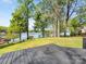 Large backyard with lush green grass and serene lake views from the deck at 1395 Roundstone Rd, Sherrills Ford, NC 28673