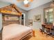 Bedroom has a unique custom headboard, wood floors, closet, and desk/vanity area at 1395 Roundstone Rd, Sherrills Ford, NC 28673