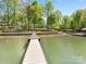 Long wooden dock extending into the calm lake, providing access to the water and scenic views at 1395 Roundstone Rd, Sherrills Ford, NC 28673