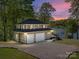 Stunning lakefront home with a two-car garage and a scenic sunset backdrop at 1395 Roundstone Rd, Sherrills Ford, NC 28673