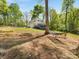 Spacious home with deck, lower garage, and inviting hammock under mature tree at 1395 Roundstone Rd, Sherrills Ford, NC 28673