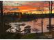 Scenic lake view at sunset with boats docked on calm water at 1395 Roundstone Rd, Sherrills Ford, NC 28673