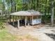 Outbuilding features a covered area and wood and metal siding at 1395 Roundstone Rd, Sherrills Ford, NC 28673