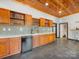 Wet bar features under cabinet refrigerator, mosaic tile backsplash, wine storage, and wood cabinets at 1395 Roundstone Rd, Sherrills Ford, NC 28673