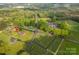 An aerial view shows a charming property with lush green landscaping, mature trees, and a well-maintained lawn at 1663 Smyre Farm Rd # 5, Newton, NC 28658
