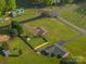 An aerial view shows a charming property with lush green landscaping, mature trees, and a well-maintained lawn at 1663 Smyre Farm Rd # 5, Newton, NC 28658