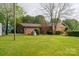 A brick house with a well-maintained lawn, mature trees, and a charming backyard at 1663 Smyre Farm Rd # 5, Newton, NC 28658