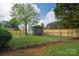 Backyard view featuring a shed, partial fence and grassy yard at 1663 Smyre Farm Rd # 5, Newton, NC 28658