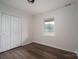 A light and bright empty bedroom featuring a closet, window, dark floors, and neutral paint at 1663 Smyre Farm Rd # 5, Newton, NC 28658