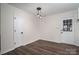 Cozy dining area with wood-look flooring, white trim, and two doorways at 1663 Smyre Farm Rd # 5, Newton, NC 28658