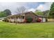 Charming brick home with a covered front porch, lush landscaping, and a spacious front yard at 1663 Smyre Farm Rd # 5, Newton, NC 28658