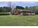 Charming brick home featuring a lush lawn, tidy landscaping, and a welcoming front porch at 1663 Smyre Farm Rd # 5, Newton, NC 28658