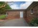 An outdoor patio with a brick house, well-maintained landscaping, and a charming backyard at 1663 Smyre Farm Rd # 5, Newton, NC 28658