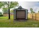 View of the backyard shed with a large garage door at 1663 Smyre Farm Rd # 5, Newton, NC 28658