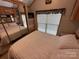 Comfortable bedroom featuring mirrored closet doors and large windows for natural light at 171 Grand View Dr, New London, NC 28127