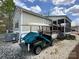 Home exterior featuring a golf cart parked beside the house with a screened-in porch at 171 Grand View Dr, New London, NC 28127