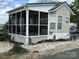 Charming manufactured home with a screened porch and well-maintained landscaping at 171 Grand View Dr, New London, NC 28127