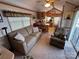 Cozy living room featuring a comfortable sofa, vaulted ceiling, and an open floor plan to the kitchen at 171 Grand View Dr, New London, NC 28127