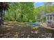 Spacious backyard with a swimming pool, lounge chairs, mature trees, and a grill area at 181 Glynwater Dr, Mooresville, NC 28117