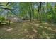 Expansive backyard with mature trees, patio, and retaining wall, perfect for outdoor living and entertaining at 181 Glynwater Dr, Mooresville, NC 28117