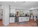 Well-lit kitchen boasts white cabinetry, stainless steel appliances, and ample counter space at 181 Glynwater Dr, Mooresville, NC 28117