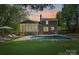 Backyard with a sparkling pool, lounge chairs, and sunroom, perfect for outdoor relaxation and entertaining at 181 Glynwater Dr, Mooresville, NC 28117