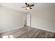 Neutral bedroom with wood-look flooring, a ceiling fan, and a view to another room at 203 E 27Th St, Kannapolis, NC 28083