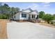 Inviting home with a new concrete driveway and well-manicured landscaping at 203 E 27Th St, Kannapolis, NC 28083