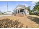 A cozy home featuring a covered porch and fresh, newly laid lawn at 203 E 27Th St, Kannapolis, NC 28083