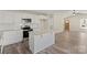 An inviting kitchen with white cabinets, stainless steel appliances, and adjacent living space at 203 E 27Th St, Kannapolis, NC 28083