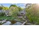 Aerial view of a luxurious waterfront estate with lush landscaping and a private dock at 20428 Island Forest Dr, Cornelius, NC 28031