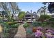 Beautiful two-story home with landscaped backyard, stone pathway, and lush flower beds at 20428 Island Forest Dr, Cornelius, NC 28031