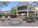 Stunning home featuring a backyard with chairs, an outdoor fireplace and lush landscaping at 20428 Island Forest Dr, Cornelius, NC 28031
