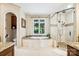 Luxurious bathroom features a glass shower, a soaking tub, and an abundance of natural light at 20428 Island Forest Dr, Cornelius, NC 28031