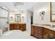 Spa-like bathroom boasts dual vanities, a walk-in shower, and custom lighting fixtures at 20428 Island Forest Dr, Cornelius, NC 28031