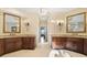 Bathroom with double vanity, granite counters, and decorative sconces at 20428 Island Forest Dr, Cornelius, NC 28031
