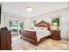 Tranquil main bedroom featuring a lake view, access to a private patio, and classic furnishings at 20428 Island Forest Dr, Cornelius, NC 28031