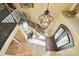 Elegant foyer with wrought iron staircase, chandelier and arched front door at 20428 Island Forest Dr, Cornelius, NC 28031